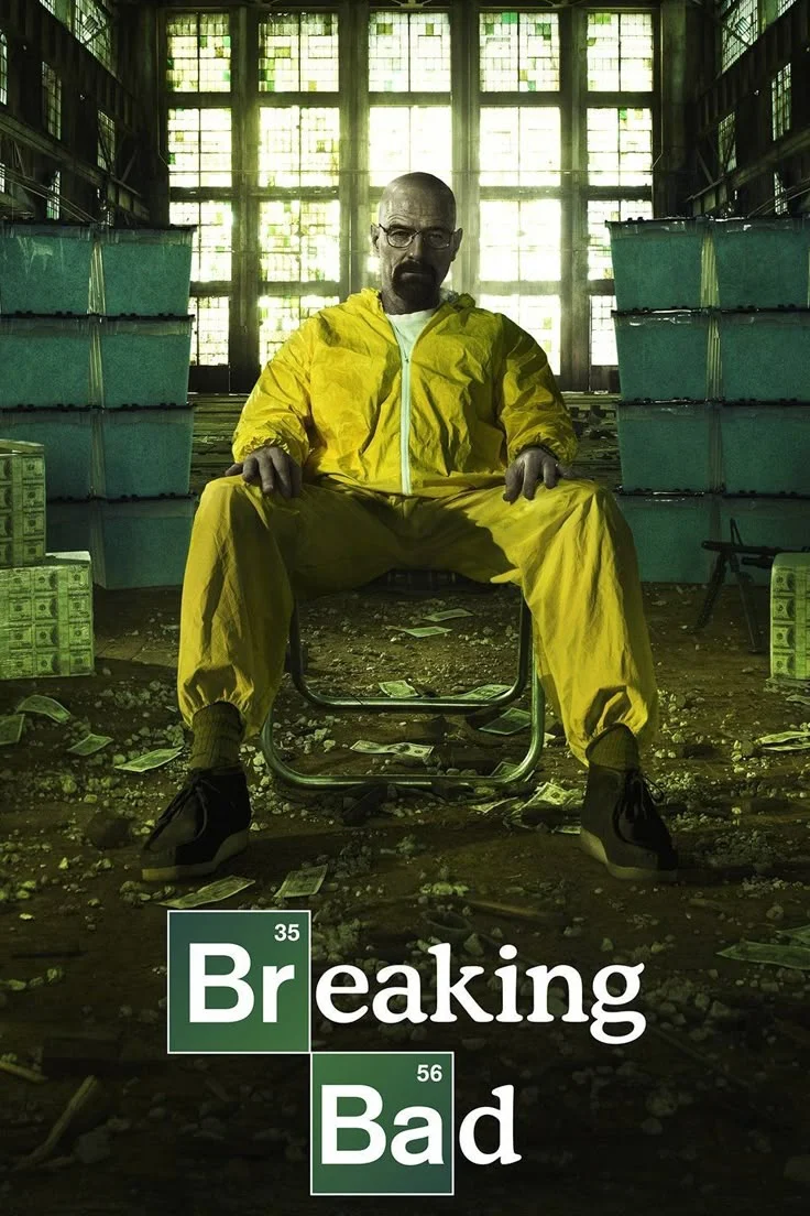Breaking Bad poster with a man in a yellow protective suit seated inside a laboratory.